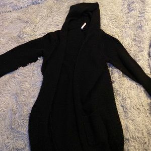A cozy black cardigan with a hood and pockets.